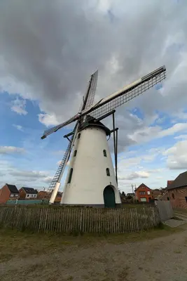 a large white windmill with a fence around it at Black Box in Lille