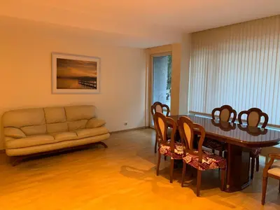 a living room with a couch and a table and chairs at lovely two bedroom apartment with free parking in Antwerp