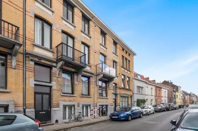 a city street with buildings and cars parked on the street at Design Studio Gent nabij station, musea &centrum in Ghent