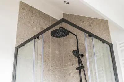a shower with two lights in a bathroom at Design Studio Gent nabij station, musea &centrum in Ghent