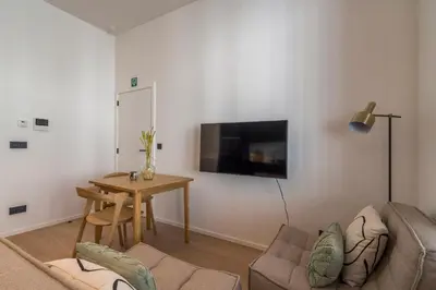 a living room with a couch and a table at Design Studio Gent nabij station, musea &centrum in Ghent