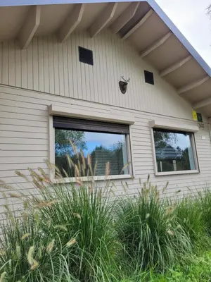 a bug on the side of a house with windows at Rustig gelegen chalet Kapeki met tuin aan het water in Geel