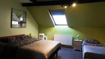 a green bedroom with two beds and a window at Apartments Marco Polo Midi in Brussels
