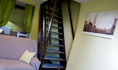 a spiral staircase in a room with a couch at Apartments Marco Polo Midi in Brussels