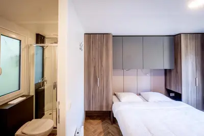 a bedroom with a bed and a toilet in it at Urban Gardens Gent in Ghent