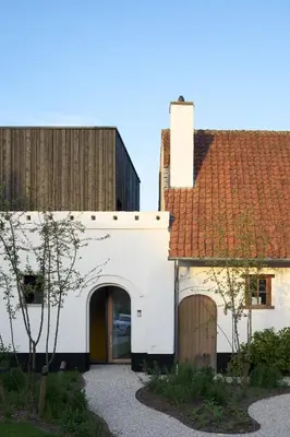 a white building with a red roof at HUIS19 Luxury apartments in Ghent