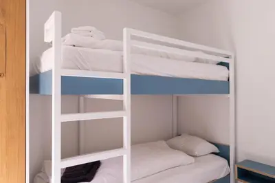 a white bunk bed in a small room at HUIS19 Luxury apartments in Ghent
