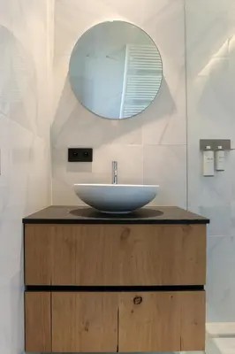 a bathroom with a sink and a mirror at HUIS19 Luxury apartments in Ghent