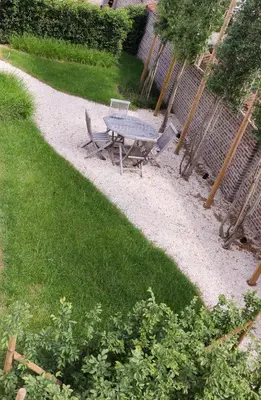 a table and chairs in a yard with grass at HUIS19 Luxury apartments in Ghent