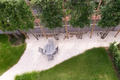 an overhead view of a park with a bench and trees at HUIS19 Luxury apartments in Ghent