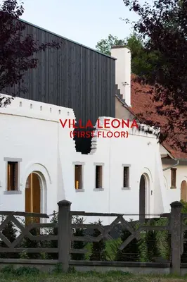 a white building with a red sign on it at HUIS19 Luxury apartments in Ghent