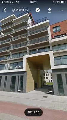 a large building with a parking lot in front of it at Cozy two bedroom Apartment near city centre Gent in Ghent