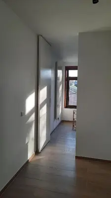 an empty room with a door and a window at The Kettle House - Manor in Sint-Pieters-Leeuw