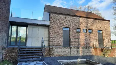 a brick building with a staircase in front of it at The Kettle House - Stable in Sint-Pieters-Leeuw