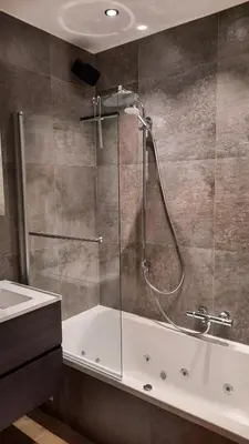 a bathroom with a shower with a tub and a sink at The Kettle House - Stable in Sint-Pieters-Leeuw