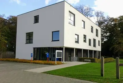 a white building with a lot of windows at Kalmdown Cabin - Antwerp in Wuustwezel