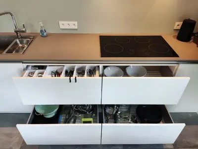 a kitchen with white cabinets and a stove at Gasthuis Puytvoet in Sint-Niklaas