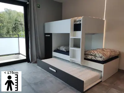 a bunk bed in a room with a window at Gasthuis Puytvoet in Sint-Niklaas