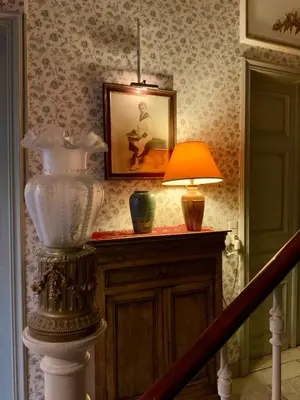 a hallway with a lamp and a picture on the wall at Freetimeflat Mies & Fien in Ghent