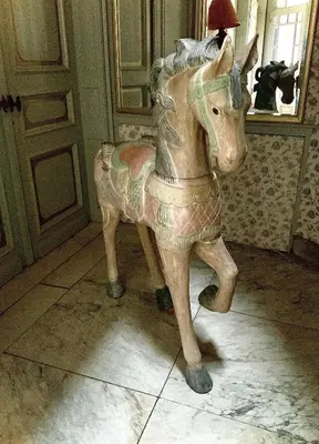 a wooden rocking horse sitting in a room at Freetimeflat Mies & Fien in Ghent