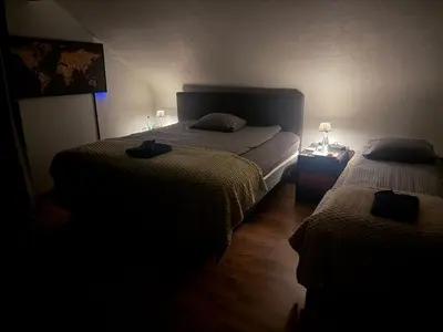 a bedroom with two beds in a dark room at Perk25A in Steenokkerzeel