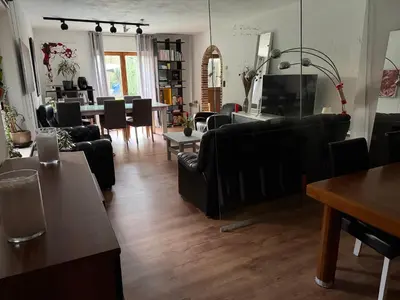 a living room with black couches and a table at Perk25A in Steenokkerzeel