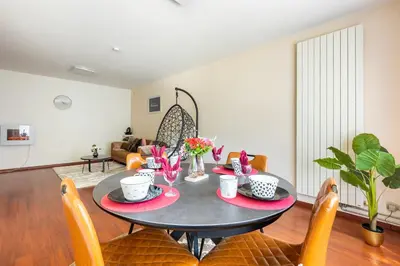 a dining room with a table and chairs at Luxe apt with parking & garden in wilrijk antwerp in Antwerp
