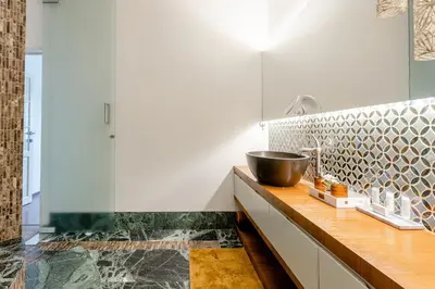 a bathroom with a sink and a bowl on a counter at Luxe apt with parking & garden in wilrijk antwerp in Antwerp