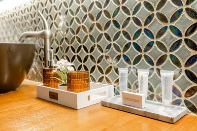 a counter with two vases and a wall at Luxe apt with parking & garden in wilrijk antwerp in Antwerp