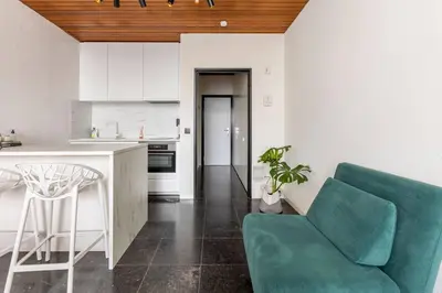 a kitchen with a green couch and a table at Riverview Studio in Historical Heart of Antwerp in Antwerp