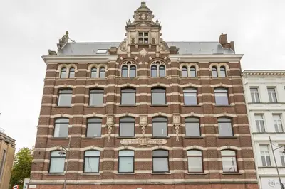 a large brick building with a clock tower on top at Riverview Studio in Historical Heart of Antwerp in Antwerp