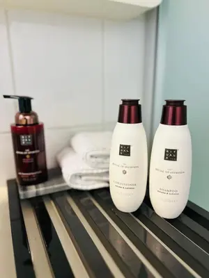 two bottles of hair products sitting on a shelf at Riverview Studio in Historical Heart of Antwerp in Antwerp