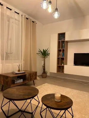 a living room with two tables and a tv at Vintage dream in Heide