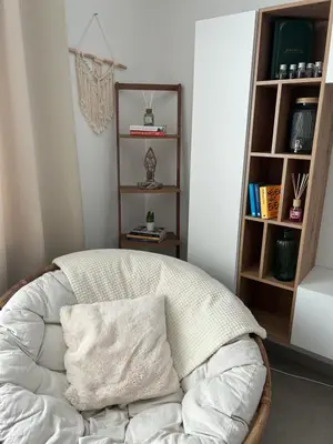 a white chair with a pillow in a room at Vintage dream in Heide