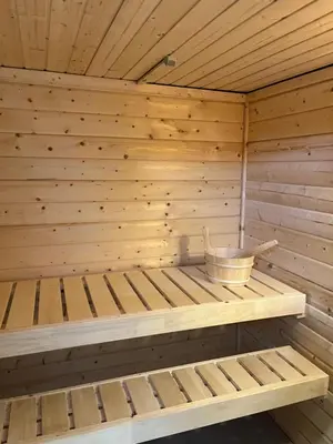 a wooden sauna with a bench in it at Rooftop terrace suite in Heist-op-den-Berg