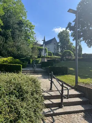 a set of stairs in front of a white house at Rooftop terrace suite in Heist-op-den-Berg