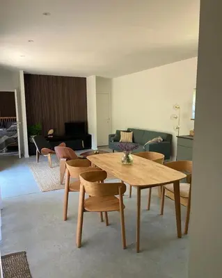 a living room with a wooden table and chairs at Osbos chalets in Lille