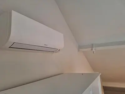 a kitchen with a white ceiling with a vent at Huis ALNA 2 in Mechelen