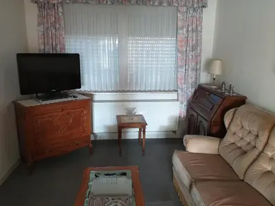 a living room with a couch and a flat screen tv at Vakantiewoning Louis in Mechelen
