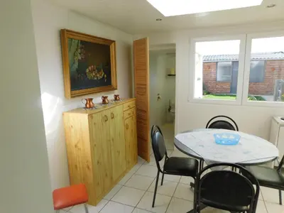 a dining room with a table and chairs and a window at Vakantiewoning Louis in Mechelen