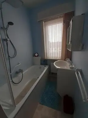 a bathroom with a shower and a tub and a sink at Vakantiewoning Louis in Mechelen
