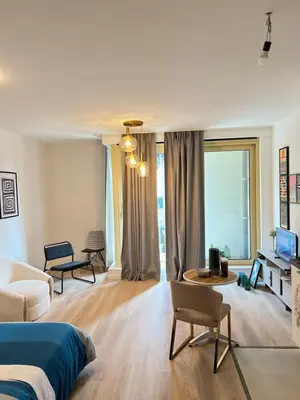 a bedroom with a bed and a living room at Hote Brussels center City luxe Tours et Taxi in Brussels