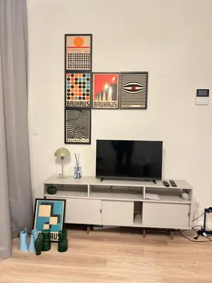 a living room with a tv on a white wall at Hote Brussels center City luxe Tours et Taxi in Brussels