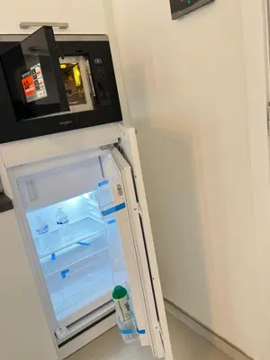 an empty refrigerator with its door open in a room at Hote Brussels center City luxe Tours et Taxi in Brussels