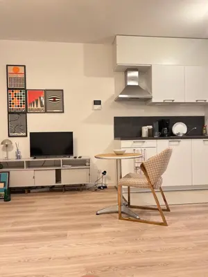a kitchen with a table and a chair in a room at Hote Brussels center City luxe Tours et Taxi in Brussels