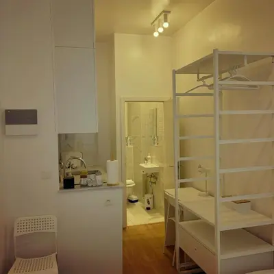 a bathroom with a sink and a shelf in a room at Benny's Rooms Brussels City Centre in Brussels