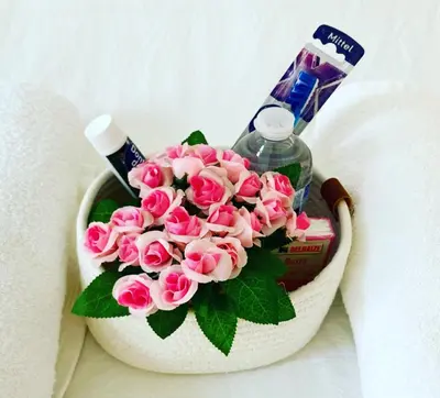 a bouquet of pink roses and a bottle of soap at Benny's Rooms Brussels City Centre in Brussels
