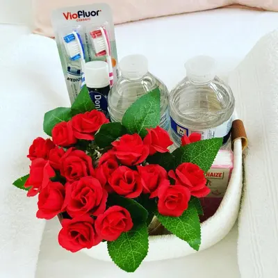 a bouquet of red roses and water bottles at Benny's Rooms Brussels City Centre in Brussels