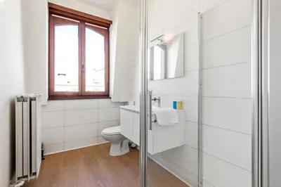 a bathroom with a toilet and a glass shower at The Old One Fifteen by Romy&Travis in Ghent