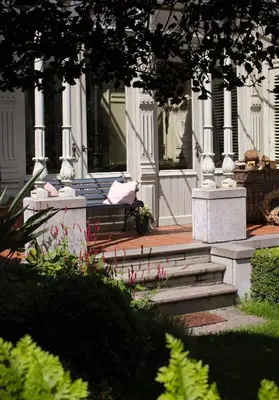 a bench in front of a building with flowers at Huis Dujardin Bed&Breakfast in Antwerp